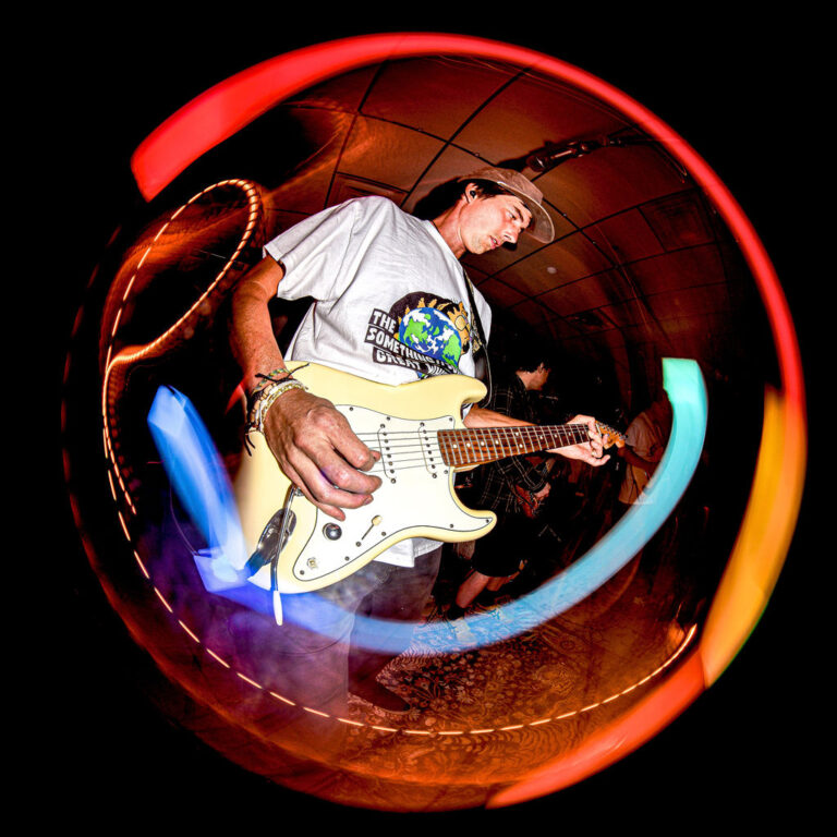trent larrabee playing electric guitar and performing with his bad